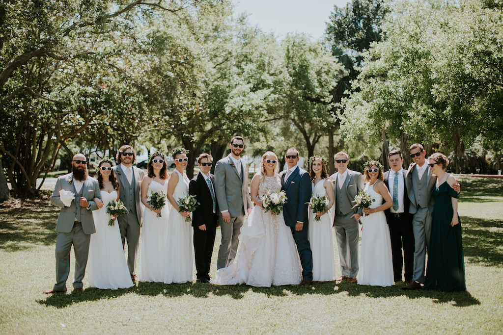 Fun Florida Bridal Party Portrait | Bridesmaids in White Mix and Match Dresses, Groomsmen in Gray Suits Wedding Party in Sunglasses Wedding Portrait