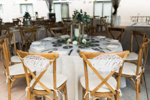 Tampa Rustic Elegant Wedding Reception Decor, Round Tables with Ivory Linen, Wooden Crossback Chairs with Lace Mr and Mrs Chair Signs, Wooden and Silver Lantern Centerpiece with Silver Dollar Eucalyptus