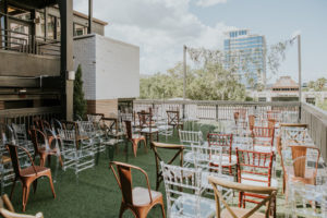 Rustic Elegant Rooftop Wedding Reception Decor, Mix and Match Chairs, Acrylic Ghost, Chiavari Chairs, Wooden Crossback Chairs, Copper Metal Chairs, Mahogany Chiavari Chairs, String Light with Hanging Greenery | Downtown St. Pete Wedding Ceremony Rooftop Venue Station House | Wedding Planner UNIQUE Weddings + Events