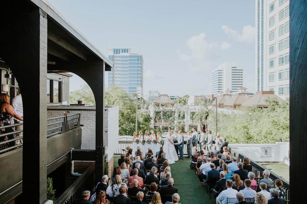 Outdoor Rooftop Wedding Ceremony Bride and Groom Exchanging Vows Wedding Portrait | Downtown St. Pete Wedding Ceremony Rooftop Venue Station House