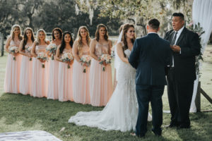 Rustic Chic Bride and Groom Exchanging Vows Under Trees Wedding Ceremony Portrait, Bridesmaids in Matching Blush Pink Sequin Bodice Dresses | Tampa Wedding Venue Rafter J Ranch
