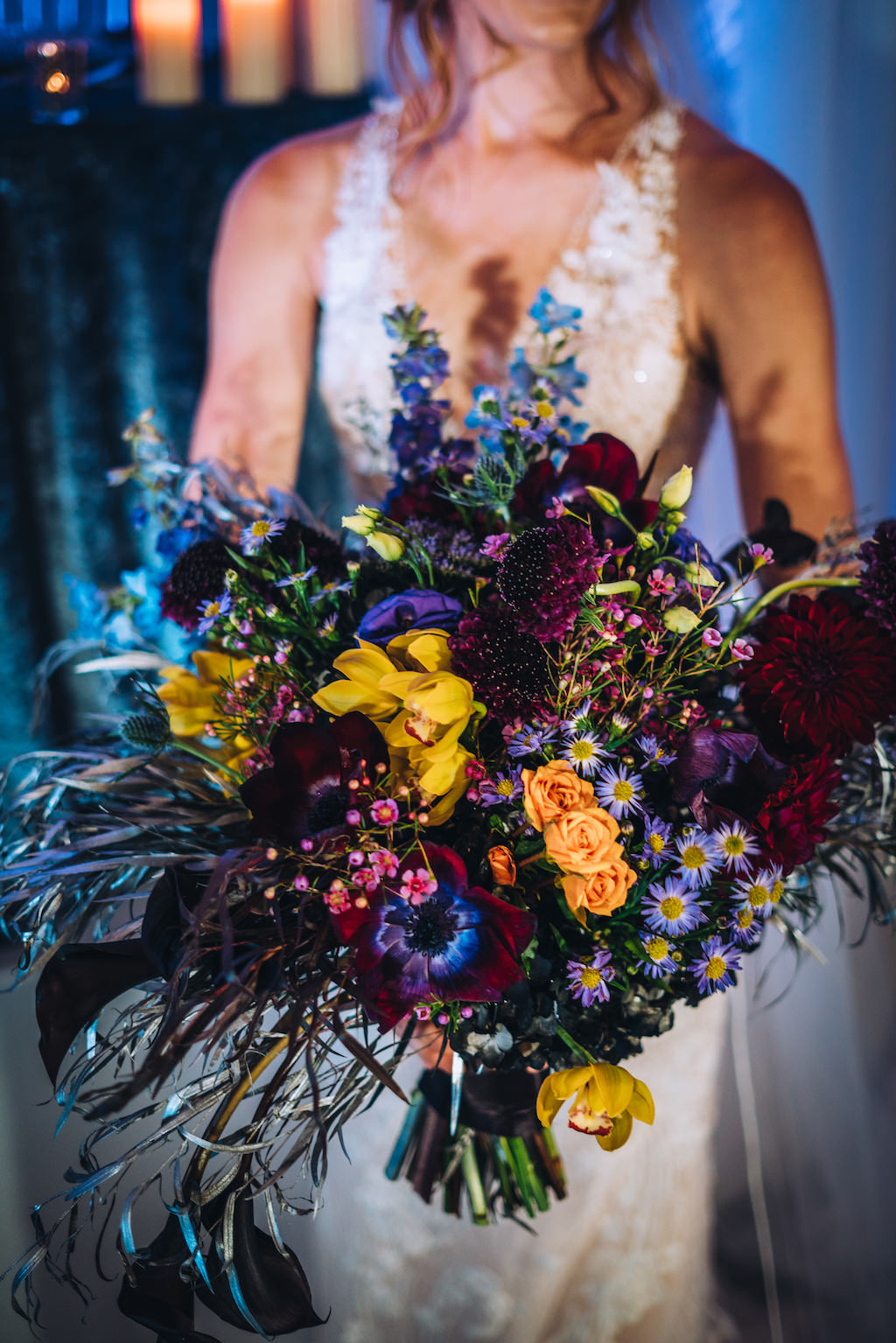 Bride Holding Unique Dramatic Dark Purple, Burgundy, Yellow, Orange Floral Bridal Bouquet | Tampa Bay Wedding Planner Special Moments Event Planner | Styled Shoot