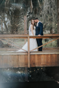 Romantic Florida Bride and Groom on Wooden Bridge Wedding Portrait | Tampa Wedding Venue Rafter J Ranch