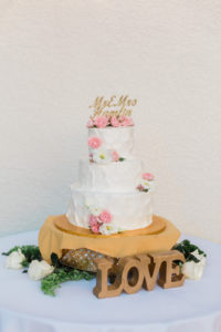 Three Tier White Wedding Cake with Pink and White Flowers and Custom Gold Glitter Laser Cut Cake Topper