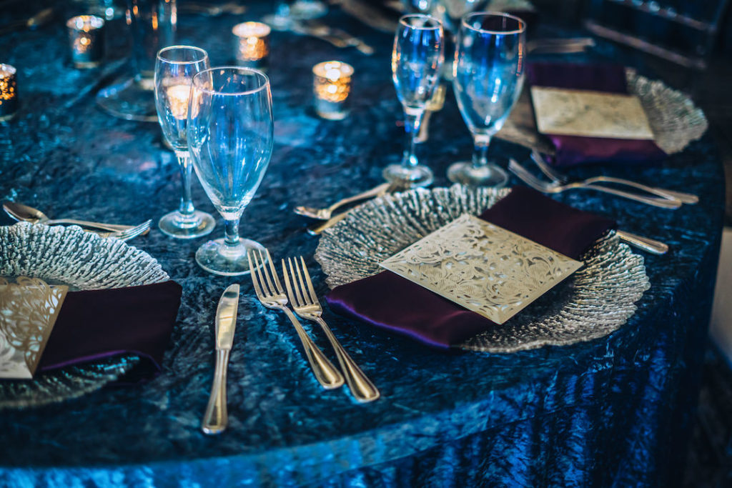 Dark Dramatic Modern Contemporary Wedding Reception Decor, Velvet Blue Linen, Silver Chargers, Purple Napkins and Silver Napkin Holder | Tampa Bay Wedding Planner Special Moments Event Planning