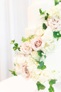 Classic Round White Wedding Cake with Cascading Blush Pink and White Roses, Baby's Breath and Greenery Leaves Flowers