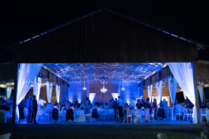 Rustic Barn Wedding Venue with Blue Uplighting and White Linen Draping and Crystal Chandeliers | Tampa Wedding Venue Rafter J Ranch | Wedding Planner Kelly Kennedy Weddings and Events