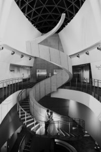 Black and White Tampa Bride and Groom Creative Wedding Portrait on Spiral Staircase | Downtown St. Pete Wedding Venue Salvador Dali Museum