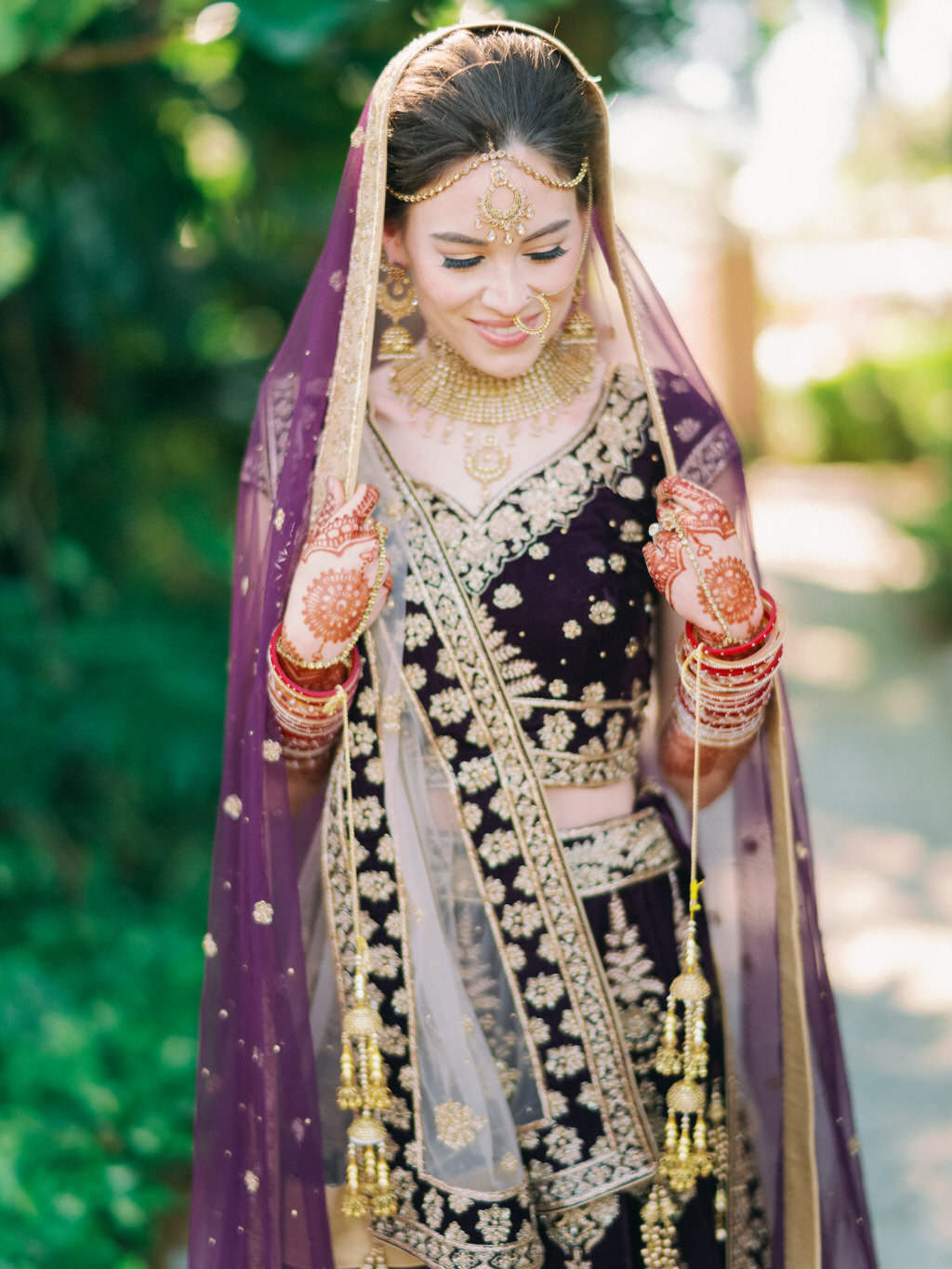 Traditional Hindu, Indian Colorful Bride, Beauty Wedding Portrait, Extravagant Gold Bridal Jewelry, Bridal Mehndi Henna Tattoo, Purple and Gold with Rhinestones Indian Bridal Veil, Custom Purple Velvet Lehenga | Tampa Bay Bridal Hair and Makeup Artist Michele Renee The Studio