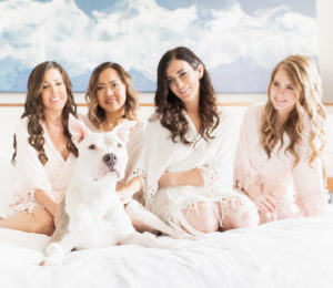 Tampa Bride, Bridesmaids in Matching Blush Pink Robes and Dog on Hotel Bed Getting Wedding Ready Portrait | Wedding Hair and Makeup Femme Akoi | Wedding Pet Planner FairyTail Pet Care
