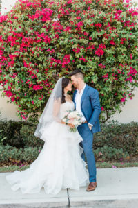 Tampa Bay Bride and Groom First Look Wedding Portrait, Bride in Rhinestone Bodice and Tulle Skirt Ballgown Wedding Dress Holding Pastel Blush Pink and White Floral Bouquet, Groom in Blue Suit | Tampa Wedding Venue The Westshore Yacht Club