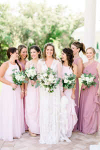 Florida Boho Inspired Bride and Bridesmaids Portrait, Wearing Mix and Match Blush, Pink Long Dresses, Holding White Floral Bouquets with Greenery | Tampa Bay Wedding Photographers Shauna and Jordon Photography | Tampa Wedding Hair and Makeup Artist Femme Akoi Beauty Studio