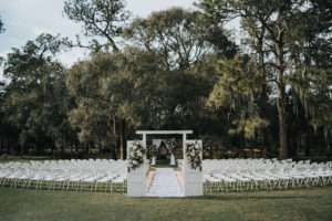 Rustic Chic Outdoor Wedding Ceremony Decor, White Barn Doors with White and Greenery Floral Arrangements | Tampa Wedding Venue Rafter J Ranch | Tampa Bay Wedding Planner Kelly Kennedy Weddings and Events