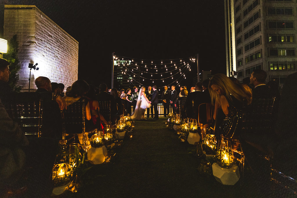 INSTAGRAM Nighttime Rooftop Wedding Ceremony Portrait, Bride and Groom Exchanging Vows Under String Lights | St. Petersburg Wedding Venue Station House