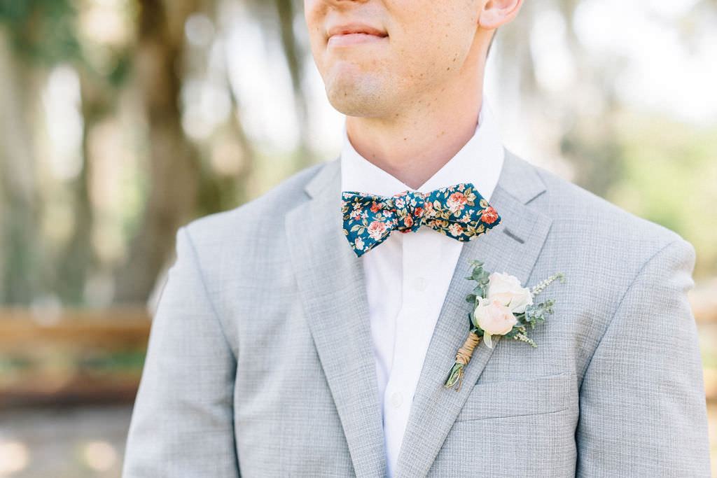 Tampa Groom in Light Gray INDOCHINO Suit, Wearing Unique Floral Print DAZI Bow Tie, Blush Pink and Ivory Rose Rustic Boutonnière