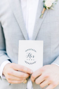 Tampa Groom Holding HIS Vows Book, Wearing Light Gray INDOCHINO Suit