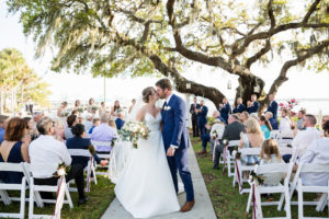 Tampa Bay Classic Bride and Groom Kiss Recessional Wedding Portrait | Waterfront Outdoor Wedding Venue Palmetto Riverside Bed and Breakfast | Wedding Planner Coastal Coordinator