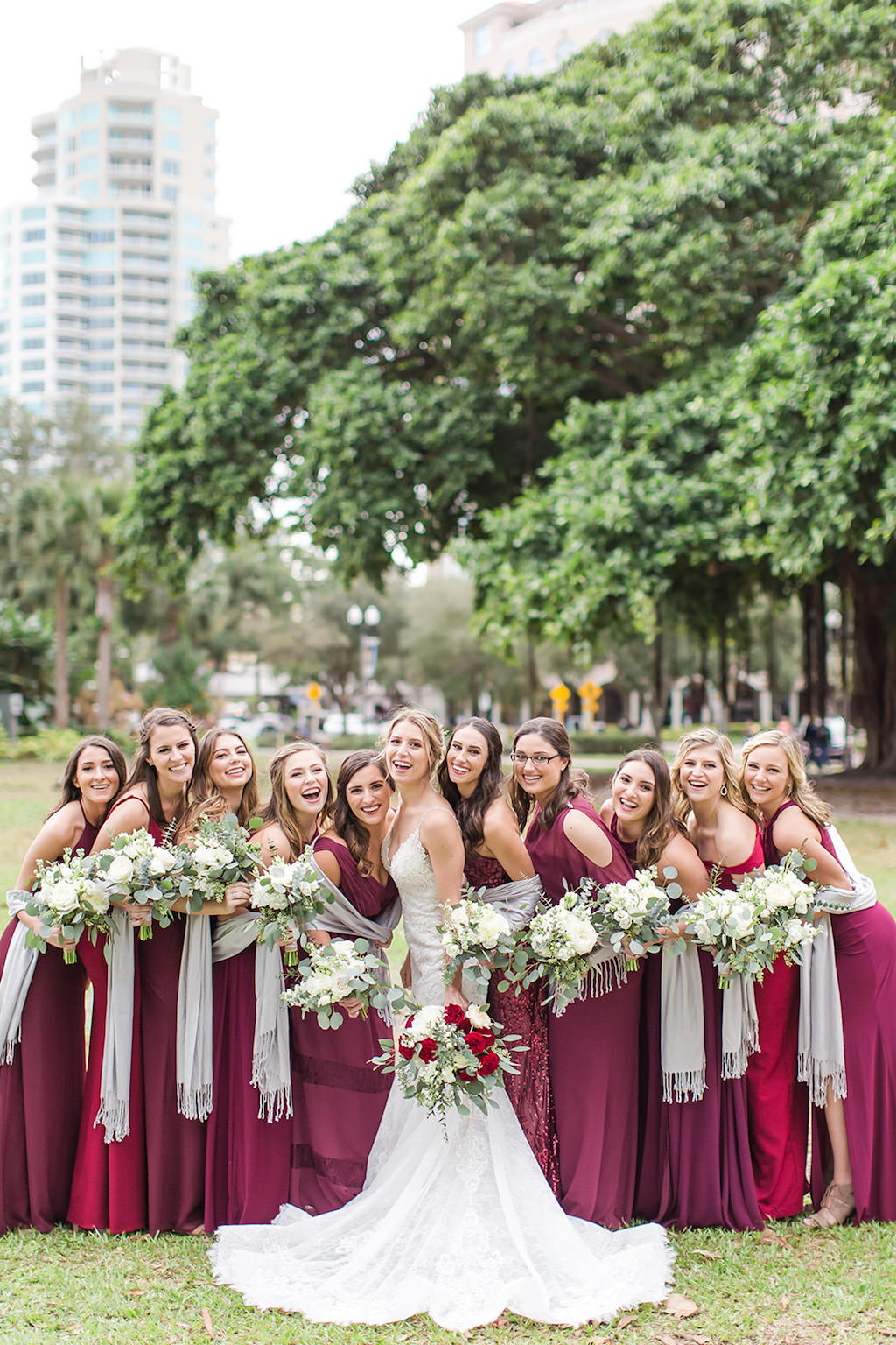 Christmas Inspired Bride and Bridesmaids, Long Garnet and Burgundy Dresses, Mix and Match Dresses Color and Style, Silver Shaw, Carrying Rustic White Bouquet with Greenery, in Downtown St. Pete Straub Park | Tampa Bay Wedding Photographers Shauna and Jordon Photography