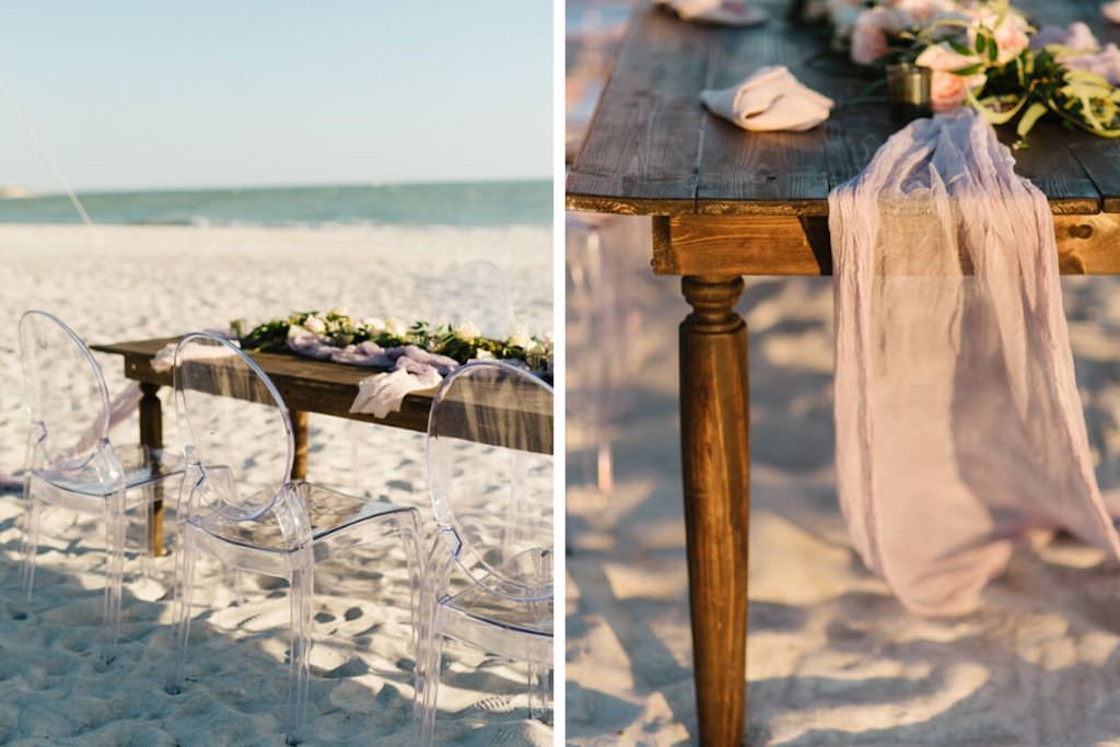 Outdoor Beachfront Wedding Reception with Long Wooden Feasting Table and Ghost Chairs with Garland of Roses and Greenery | Resort at Longboat Key Club Sarasota Area Wedding Venue