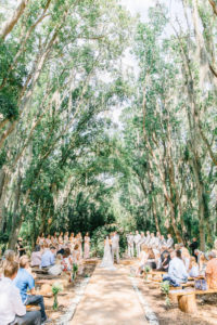 Enchanting Outdoor Wedding Under Canopy of Oak Trees, Bride and Groom Exchanging Wedding Vows During Ceremony Portrait | Whimsical Tampa Bay Venue Florida Rustic Barn Weddings