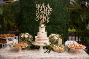 Classic Elegant Wedding Reception Dessert Table, Three Tier Semi Naked Wedding Cake, Donuts, Cookies and Cream Puffs, Ivory Greenery Backdrop with Laser Cut Sign | Tampa Bay Wedding Planner Coastal Coordinating
