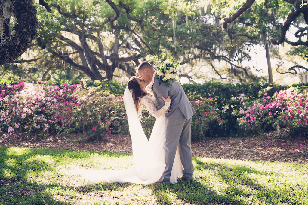 Florida Bride and Groom Intimate Embrace Kiss Dip Wedding Portrait in Outdoor Garden | Tampa Bay Wedding Photographer Luxe Light Images
