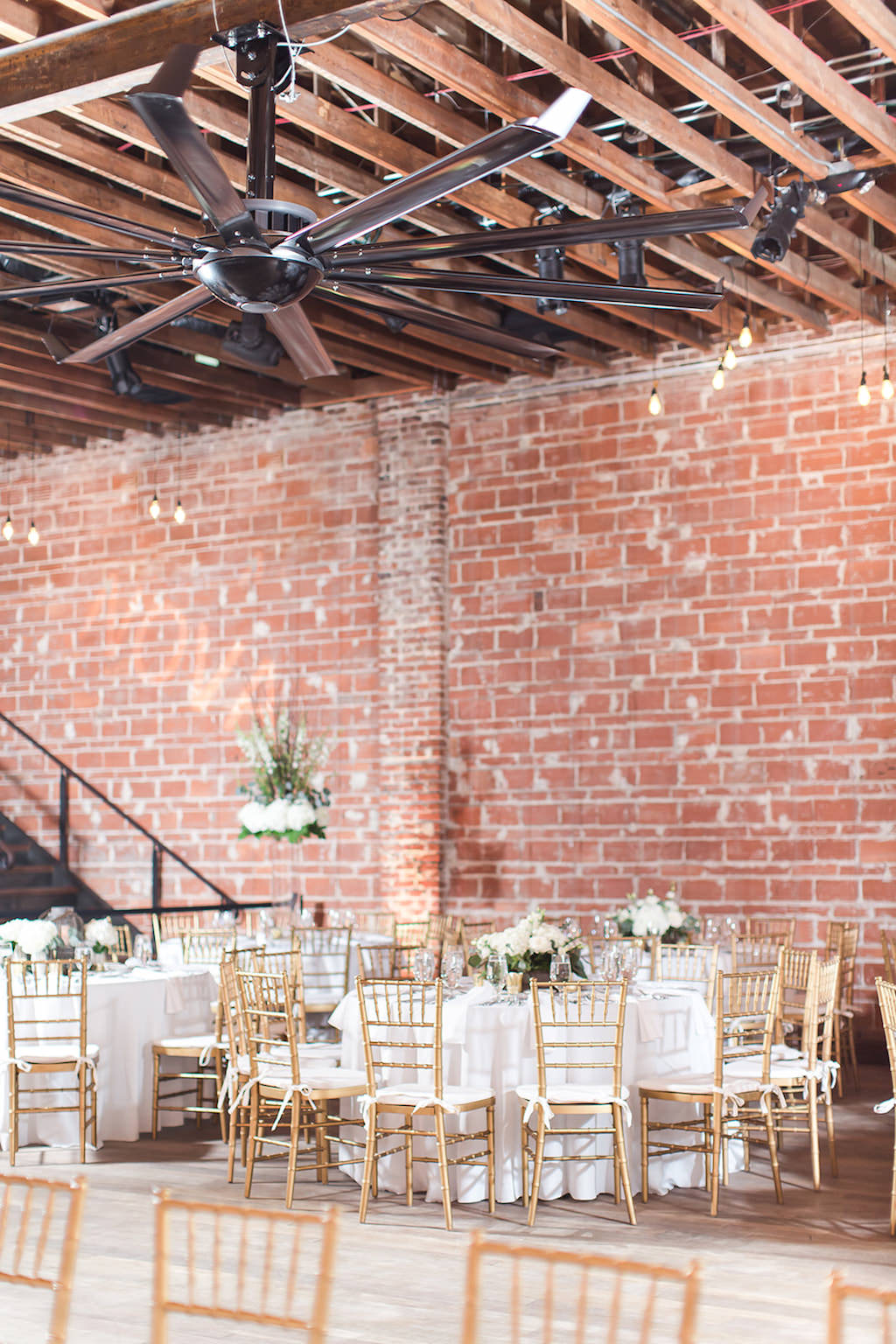 Rustic Chic Wedding Decor and Reception, Round Tables with Gold Chiavari Chairs, Against Exposed Red Brick Wall | Florida Historic Wedding Venue NOVA 535 | Tampa Bay Wedding Photographers Shauna and Jordon Photography