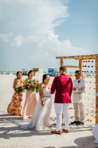 Tropical Beachfront Bride and Groom Exchanging Wedding Vows During Wedding Ceremony Portrait | St. Pete Wedding Venue Postcard Inn on the Beach