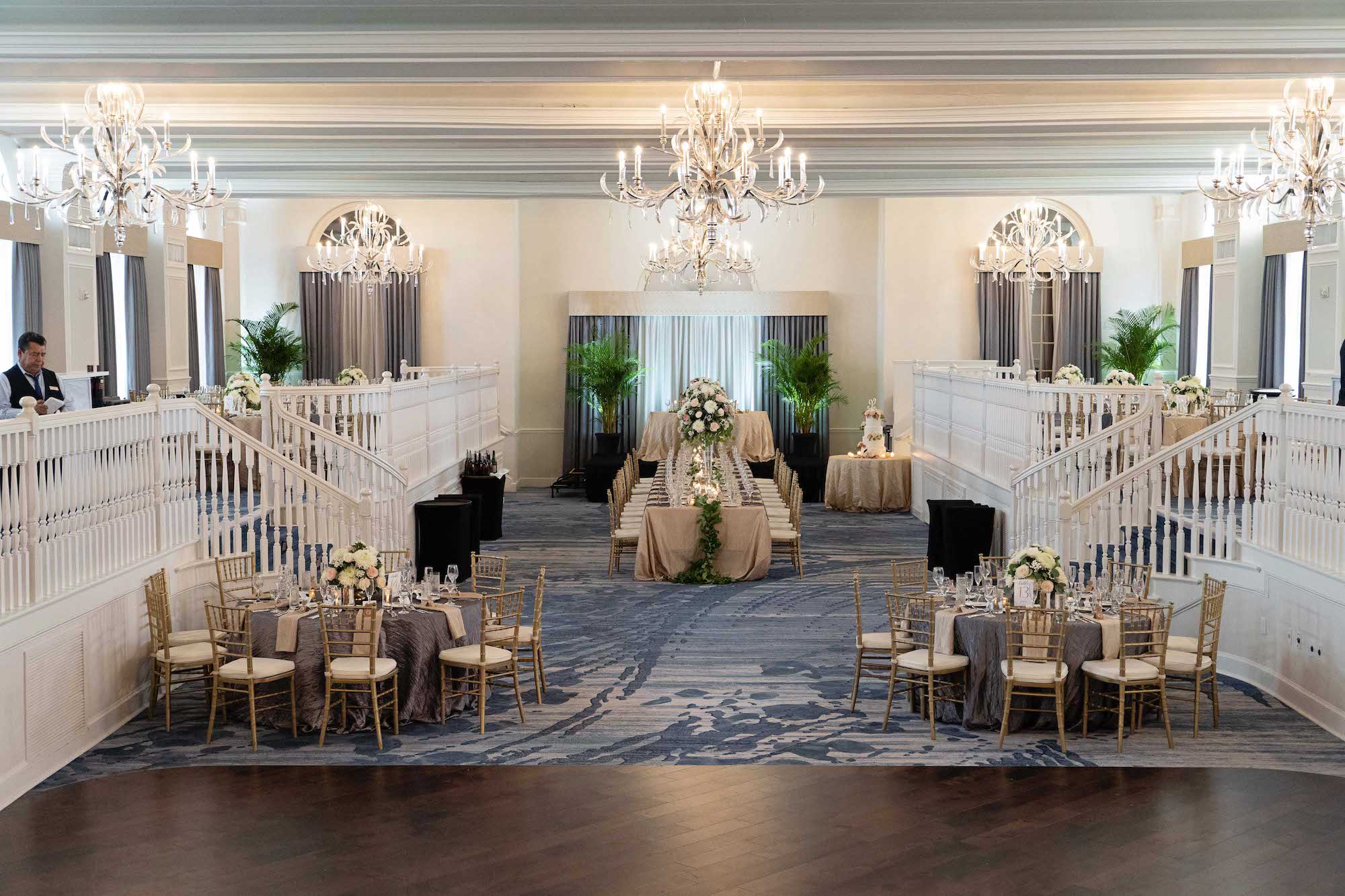 Elegant Summer Wedding in Two Tier Grand Ballroom, Gold Chiavari Chairs with Wedding Party Head Table, Round Tables with Silver and Gold Linens, Palm Leaf Decor, Low Floral Centerpieces with White and Blush Pink Flowers | Tampa Bay Historic Wedding Venue The Don CeSar on St. Pete Beach