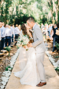 Romantic Tampa Bay Bride and Groom First Kiss Just Married At End of Alter in Outdoor Garden Ceremony | Florida Rustic Barn Weddings