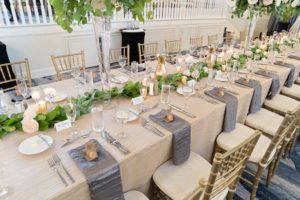 Elegant Summer Wedding in Two Tier Grand Ballroom, Gold Chiavari Chairs with Wedding Party Head Table, with Silver and Gold Linens, Palm Leaf Decor, Low Floral Centerpieces with White and Blush Pink Flowers | Tampa Bay Historic Wedding Venue The Don CeSar on St. Pete Beach