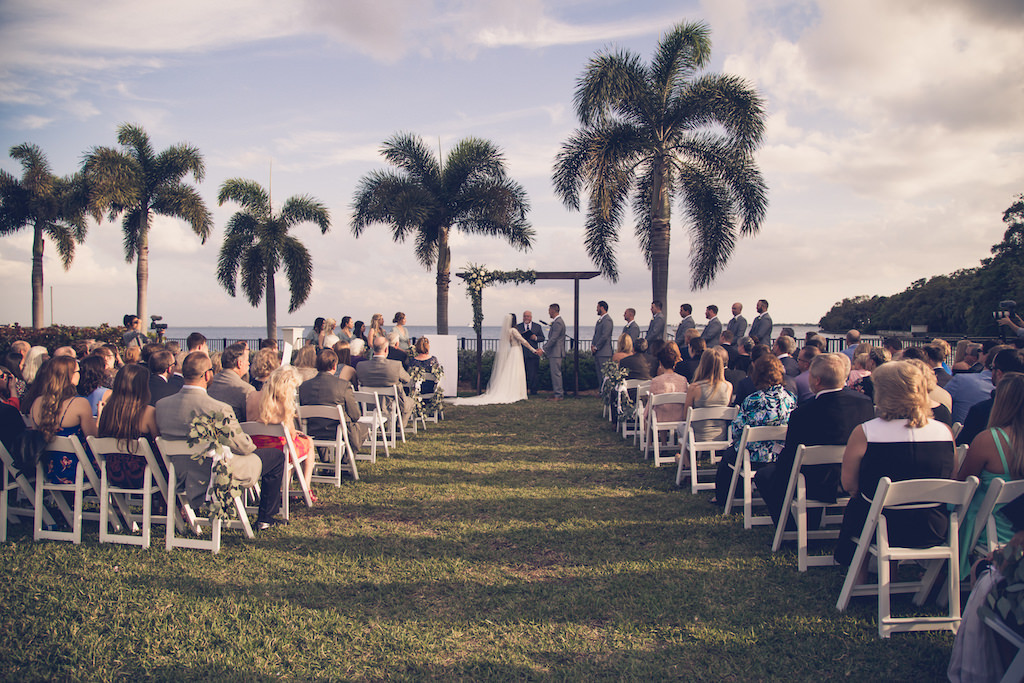 Tampa Bay Bride and Groom Exchange Vows at the Altar in Outdoor Waterfront Wedding Ceremony | Florida Wedding Photographer Luxe Light Images | Wedding Venue Tampa Yacht and Country Club