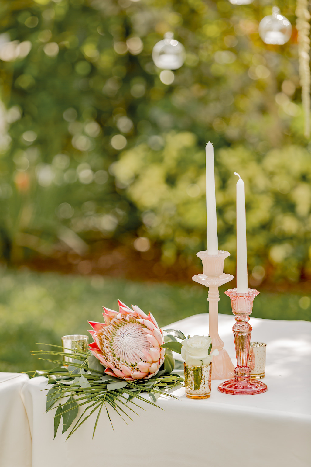 St. Pete Garden Wedding Reception Decor, King Protea Flower and Eucalyptus with Pink Glass Candlesticks