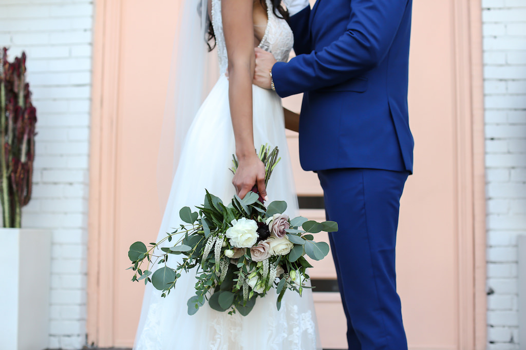Florida Bride and Groom Wedding Portrait, Bride in Lace and Tulle Skirt Wedding Dress Holding Organic Silver Dollar Eucalyptus, Blush Pink and White Roses Floral Bridal Bouquet, Groom in Blue Suit | Tampa Wedding Photographer Lifelong Photography Studio
