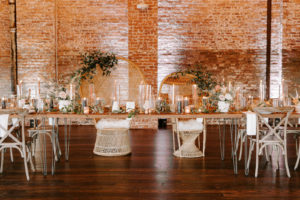INSTAGRAM Boho Whimsical Wedding Reception Decor, Long Feasting Table with Tall Hurricane Glass Candle Vases, Palm Fronds and White, Blush Pink and Burnt Orange Floral Arrangments, Wicker Dome Mr and Mrs Chairs | Tampa Bay Wedding Planner Coastal Coordinating | Industrial Wedding Venue Armature Works