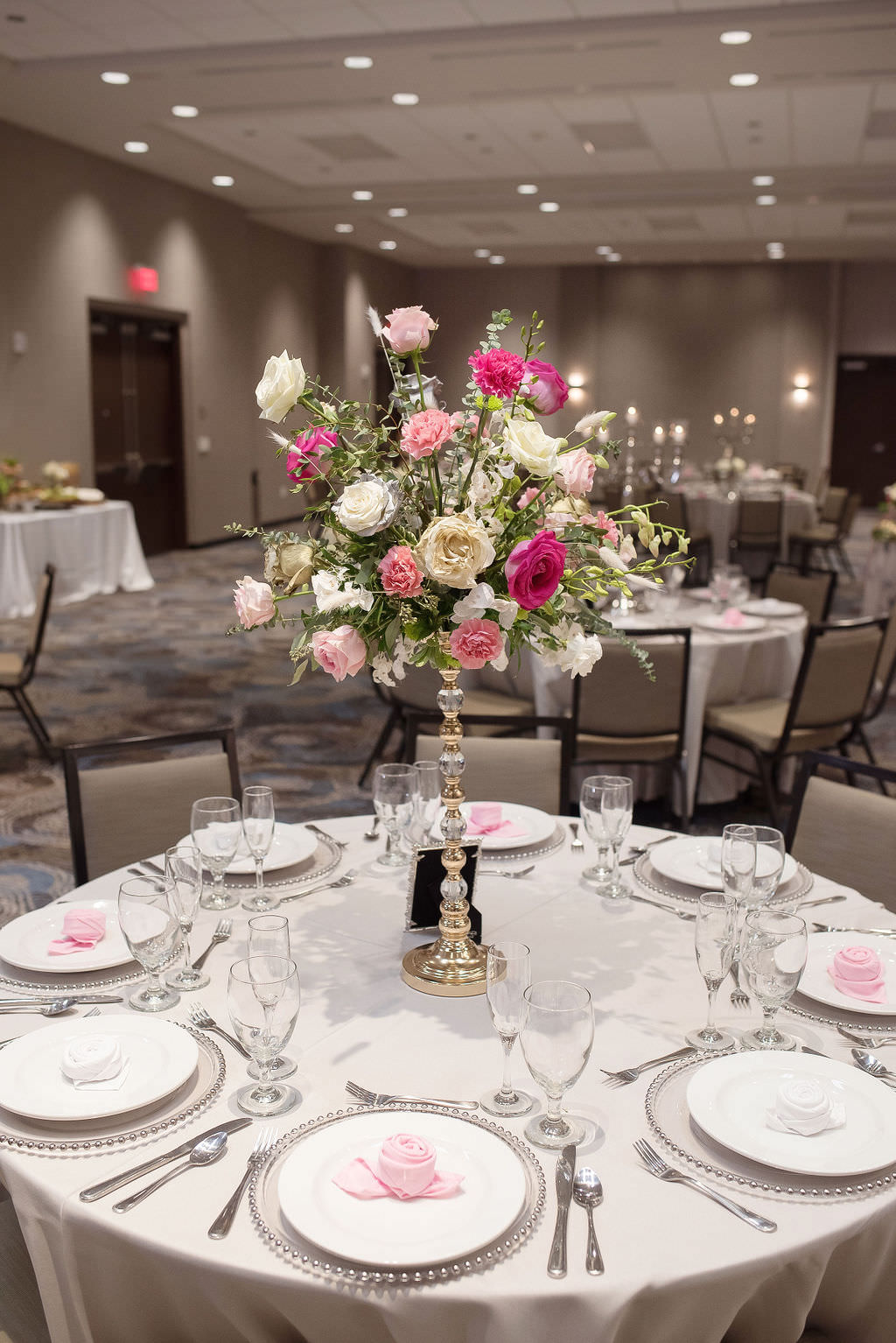 Colorful Ballroom Wedding Reception Decor, Round Tables with Gray Linens, Tall Candlestick with Fuchsia Pink, Blush Pink, Ivory Roses and Greenery Floral Centerpiece | Tampa Bay Wedding Photographer Kristen Marie Photography | Hotel Wedding Venue Hyatt Place Downtown St. Pete | Wedding Florist Brides N Blooms | Outside the Box Event Rentals
