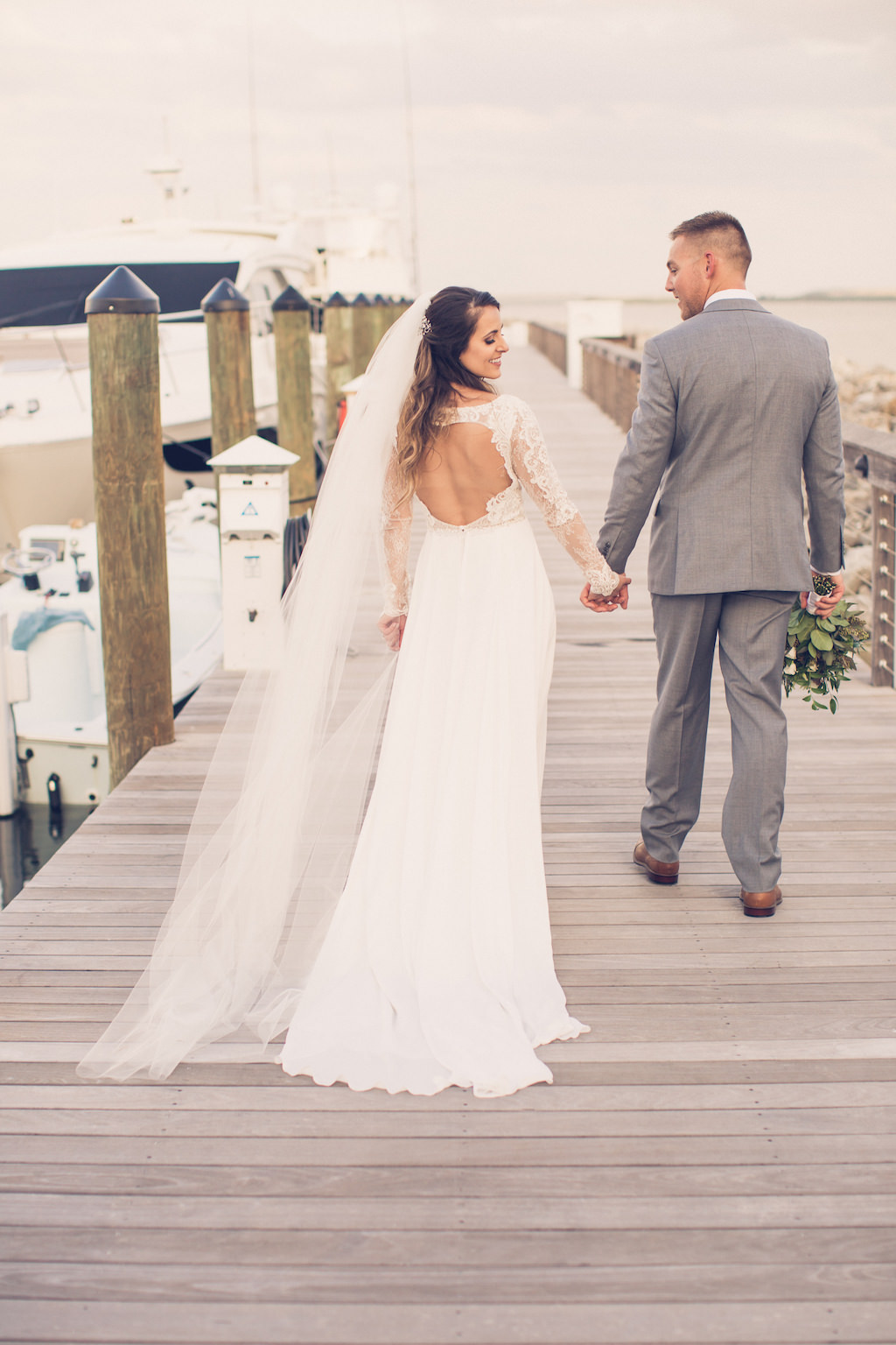 Boho Elegant Inspired South Tampa Bride and Groom on Pier at Sunset Holding Rustic Chic Wedding Bouquet | Tampa Bay Wedding Photographer Luxe Light Photography | Florida Wedding Photographer Luxe Light Images | Wedding Venue Tampa Yacht and Country Club