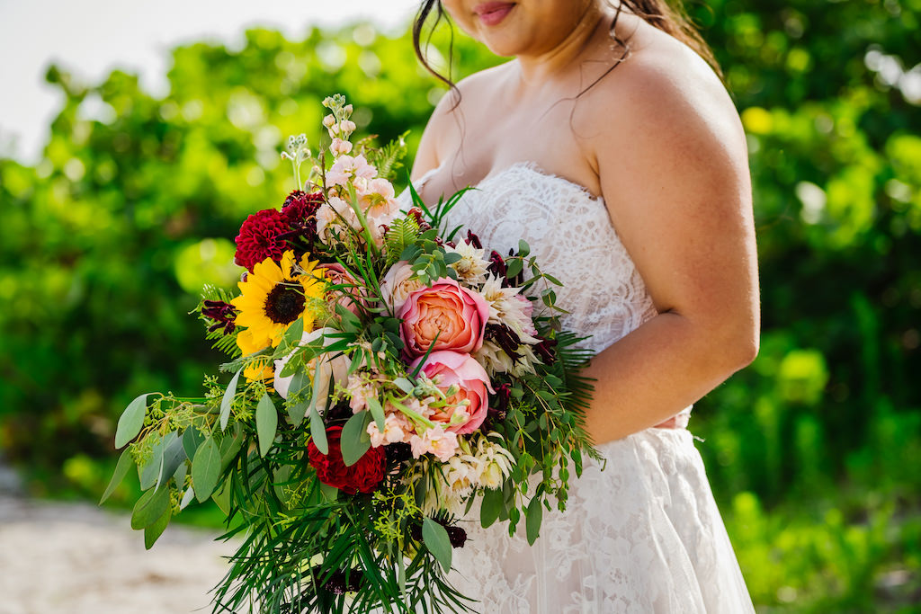 St. Petersburg Bride Holding Tropical Organic Yellow Sunflower, Red Carnation, Pink Roses and Greenery Floral Bridal Bouquet