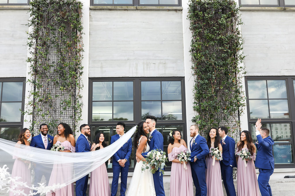 Florida Bride, Groom, Wedding Party Portrait, Bridesmaids in Matching Off the Shoulder Pink Dresses, Groomsmen in Blue Suits, Brides Cathedral Length Veil Blowing in Wind | Tampa Bay Wedding Photographer Lifelong Photography Studio