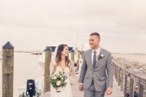 Boho Elegance Inspired South Tampa Bride and Groom on Pier at Sunset at Tampa Yacht Club, Holding Rustic Chic Wedding Bouquet with White Roses and Greenery | Tampa Bay Wedding Photographer Luxe Light Photography | Florida Wedding Photographer Luxe Light Photography
