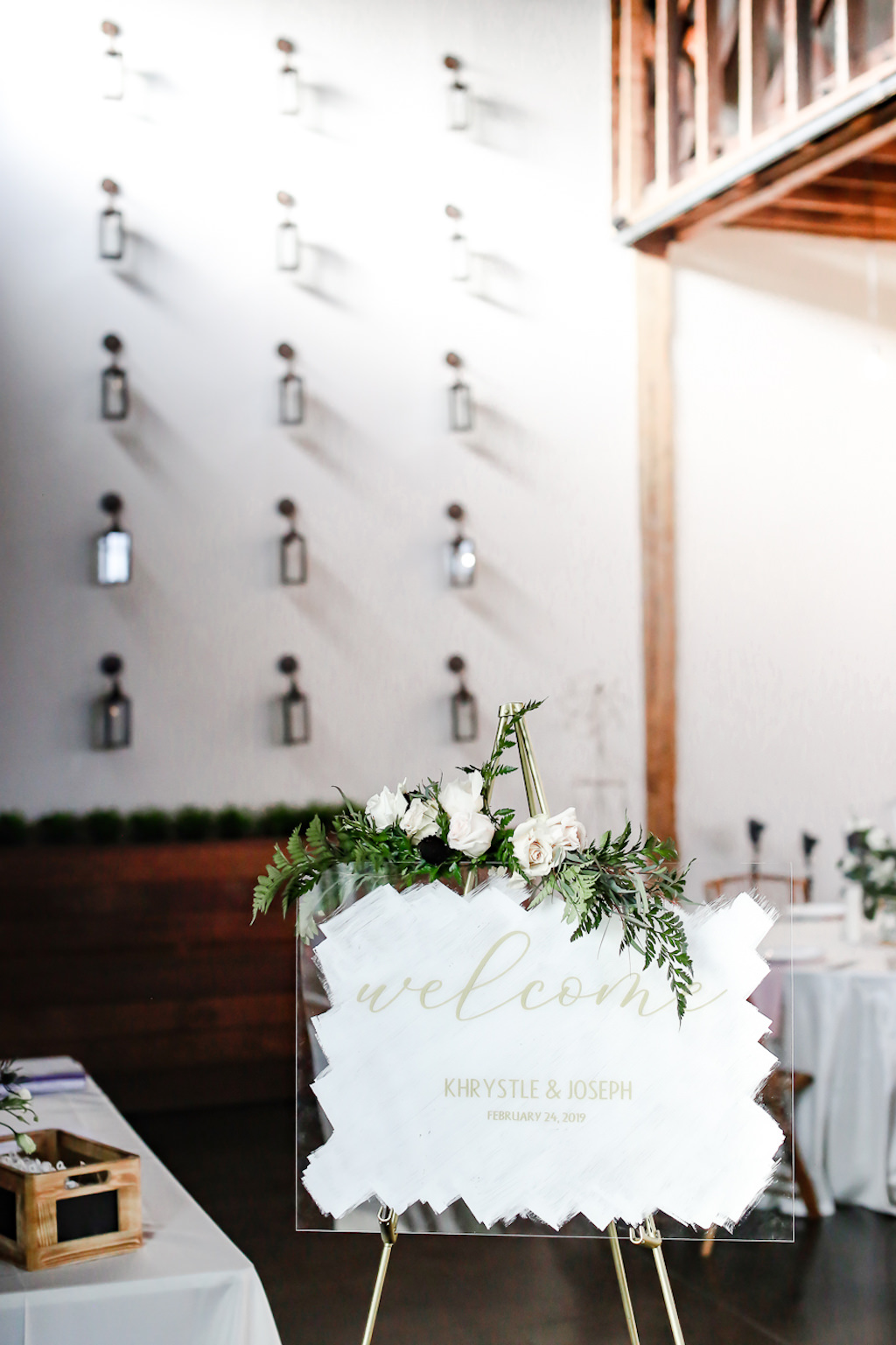 Industrial Boho Chic Wedding Reception Decor, White Painted Acrylic Plexiglass with Gold Script Welcome Sign with Greenery and Ivory Roses Arrangement | Tampa Wedding Planner Special Moments Event Planning | Wedding Photographer Lifelong Photography Studio