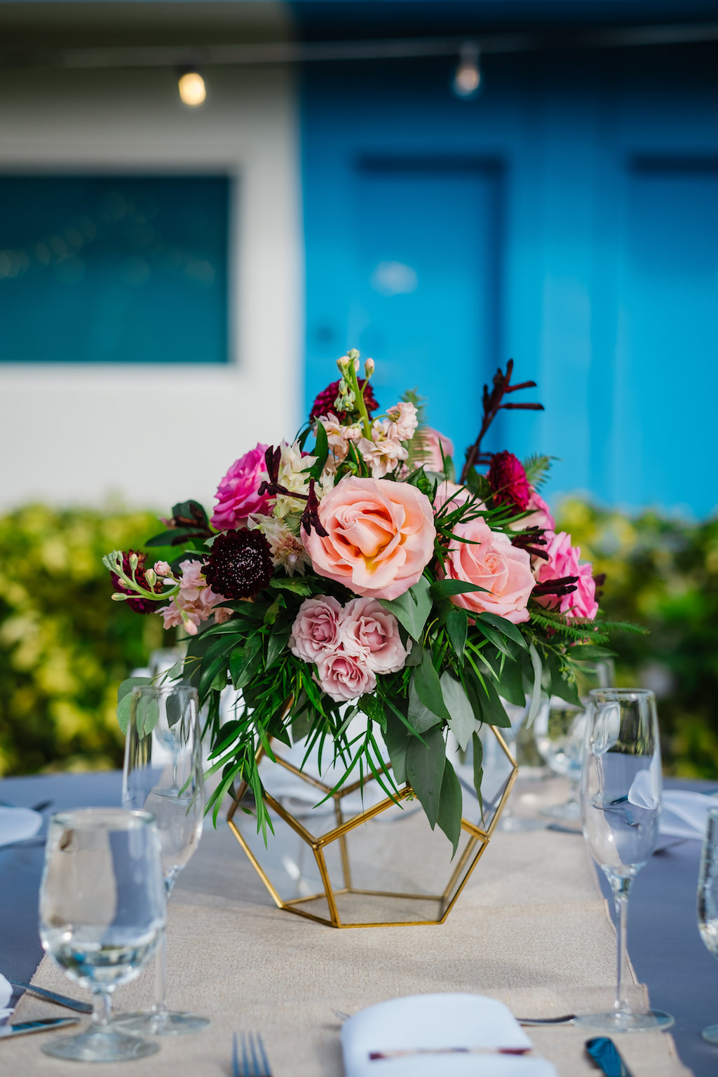 Tropical Elegant Wedding Reception Decor, Gold and Clear Glass Geometric Vase with Pink and Blush Roses, Greenery and Dark Purple Floral Centerpiece