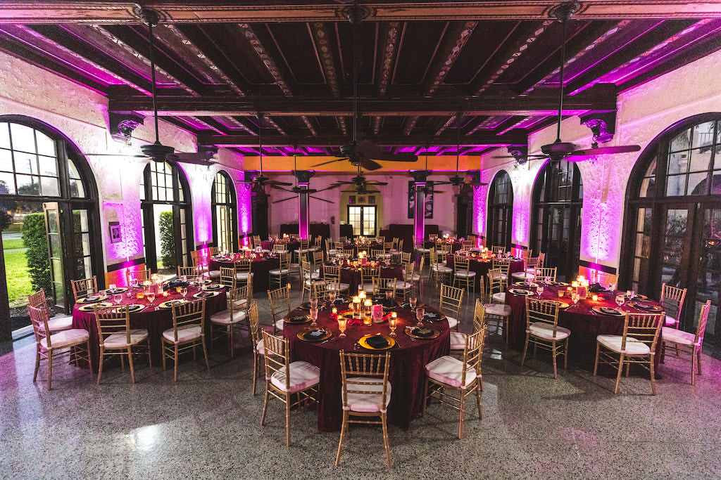 Boho Chic Wedding Reception Decor, Pink Uplighting, Round Tables with Merlot Linens, Gold Chiavari Chairs, Gold Chargers | St. Petersburg Wedding Reception Venue Admiral Ferragut Academy | Wedding Linens and Caterer Olympia Catering & Events