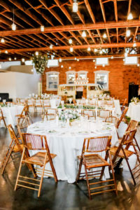 Industrial Boho Chic Wedding Reception Decor, Round Table with White Linens, Bamboo Wooden Chairs, Low Floral Centerpiece | Tampa Bay Wedding Photographer Lifelong Photography Studio | Wedding Planner Special Moments Event Planning | Wedding Tables, Chairs, Linen Rentals Gabro Event Services | Wedding Venue CAVU