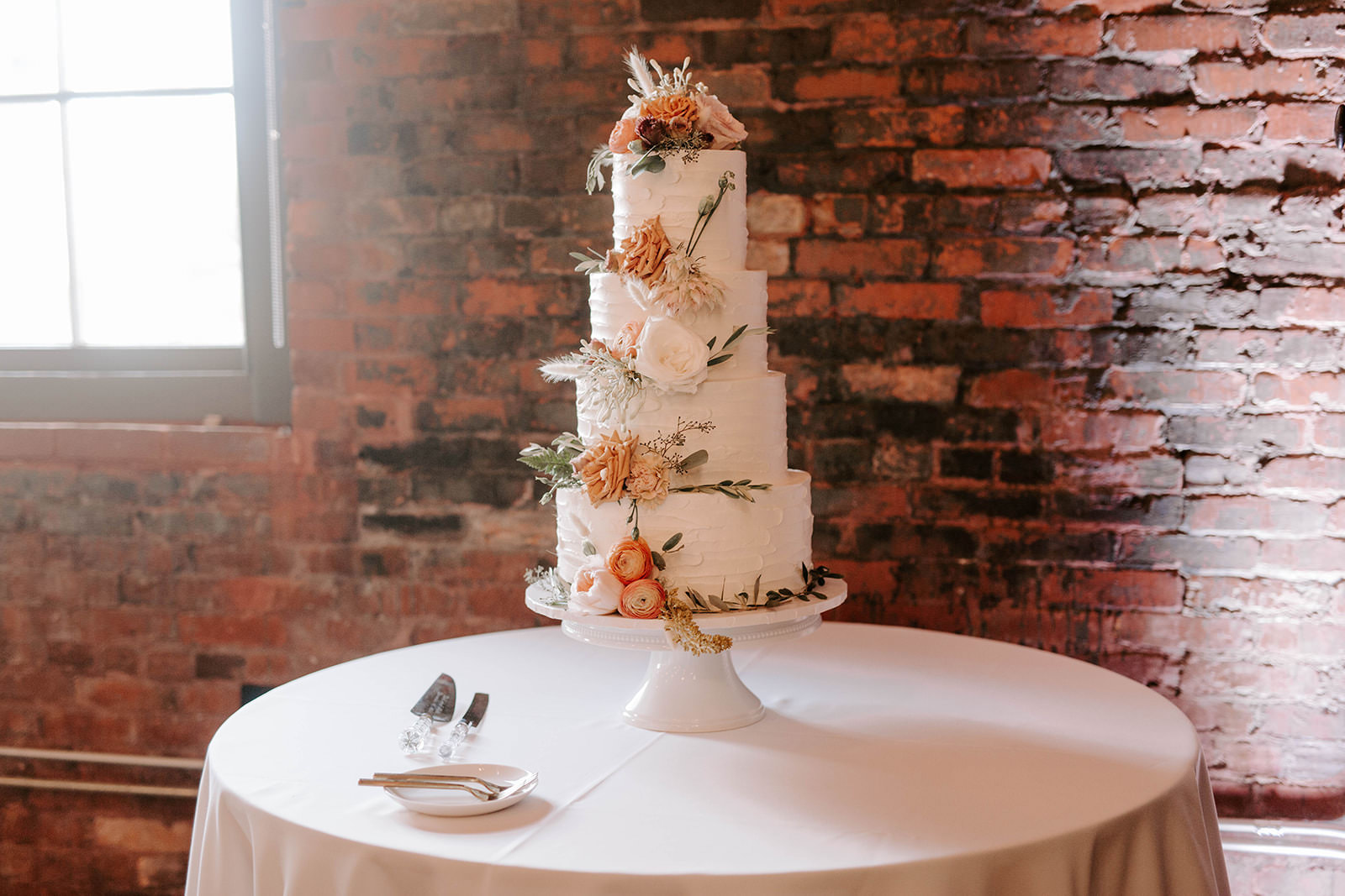 Boho Whimsical Four Tier White Ruffled Buttercream Wedding Cake Garnished with Real Burnt Orange Peonies, White and Blush Pink Roses | Tampa Bay Wedding Cake Bakery The Artistic Whisk | Tampa Bay Wedding Planner Coastal Coordinating