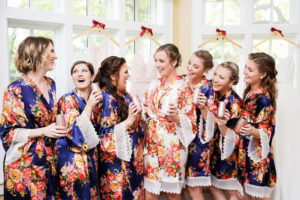 Tampa Bay Bride and Bridesmaids in Navy Blue Floral Robes Fun Cheers Getting Ready Wedding Portrait