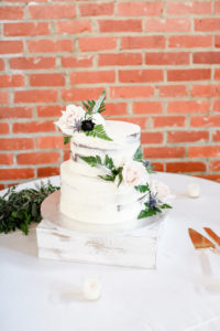 Semi Naked White Buttercream Two Tier Wedding Cake With Blush Pink Roses, Greenery and Blue Thistle Real Flowers | Tampa Wedding Photographer Lifelong Photography Studio | Wedding Planner Special Moments Event Planning