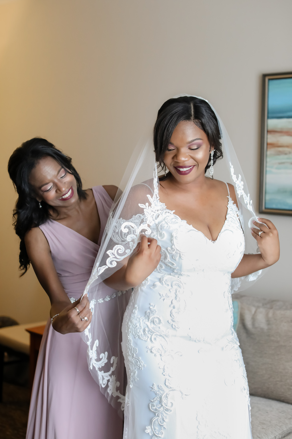 Bride Getting Ready Wedding Portrait in Fitted Lace V Neck Off the Shoulders Wedding Dress and Classic Veil with Bridesmaids in Mauve Dress | Tampa Wedding Photographer Lifelong Photography Studio | Wedding Hair and Makeup Michele Renee the Studio | Wedding Dress Boutique Truly Forever Bridal