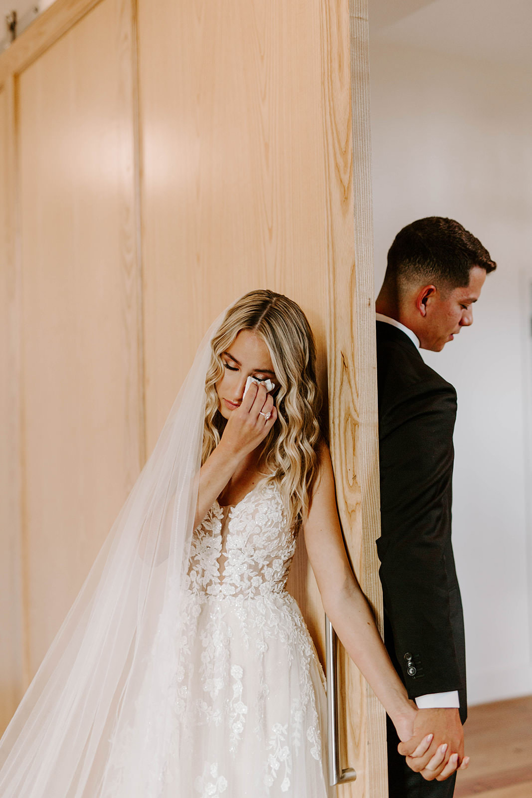 Emotional Tampa Bay Bride and Groom Holding Hands Before First Look Portrait, Bride in Whimsical Boho Lace and Tulle V Neck Martina Liana Wedding Dress and Cathedral Length Veil
