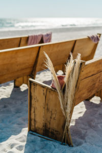 Longboat Key Club Beachfront Wedding Ceremony with Wooden Pews with Dry Beach Grass Aisle Decor | Resort at Longboat Key Club Waterfront Beach Wedding Venue